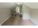 A bedroom featuring neutral walls, carpeting, a closet, and a staircase at 204 S Conger St, Saint Paul, IN 47272