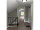 This bedroom features neutral walls, carpeting, a staircase, and a closet at 204 S Conger St, Saint Paul, IN 47272