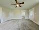 A bright bedroom with neutral paint, ceiling fan, and plush gray carpeting at 204 S Conger St, Saint Paul, IN 47272