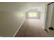 A bedroom featuring neutral walls, carpeting, a window and a built-in ceiling light at 204 S Conger St, Saint Paul, IN 47272