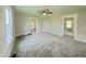 A bright bedroom with neutral paint, ceiling fan, and plush gray carpeting at 204 S Conger St, Saint Paul, IN 47272
