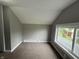 This bedroom features neutral walls, carpeting, and a window that provides natural light at 204 S Conger St, Saint Paul, IN 47272