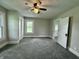 A charming bedroom with neutral walls, carpet, ceiling fan and natural light from the windows at 204 S Conger St, Saint Paul, IN 47272
