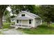 Charming home featuring a covered front porch, well-maintained lawn, and mature landscaping at 204 S Conger St, Saint Paul, IN 47272