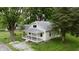 Charming home featuring a covered front porch, well-maintained lawn, and mature landscaping at 204 S Conger St, Saint Paul, IN 47272