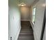 Hallway with a window and an open door with vinyl flooring at 204 S Conger St, Saint Paul, IN 47272