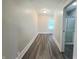 Hallway featuring wood flooring and access to the full bathroom at 204 S Conger St, Saint Paul, IN 47272