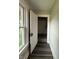 Hallway with a window, an open door, and vinyl flooring at 204 S Conger St, Saint Paul, IN 47272