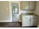 Eat-in kitchen featuring hardwood floors, gray cabinets, and granite countertop at 204 S Conger St, Saint Paul, IN 47272