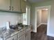 Close up of eat-in kitchen featuring granite countertop and gray cabinets at 204 S Conger St, Saint Paul, IN 47272