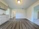 Eat-in kitchen featuring hardwood floors, gray cabinets, and lots of natural light at 204 S Conger St, Saint Paul, IN 47272