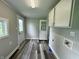 Laundry room with vinyl flooring, a window, an exterior door, and washer and dryer hookups at 204 S Conger St, Saint Paul, IN 47272