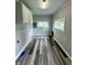 Laundry room featuring vinyl flooring, windows, washer and dryer hookups, and upper cabinets at 204 S Conger St, Saint Paul, IN 47272