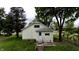 Charming home featuring a well-maintained lawn, mature trees, and concrete steps at 204 S Conger St, Saint Paul, IN 47272