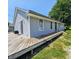 This home features a wooden deck accessible through sliding glass doors, with gray vinyl siding at 2041 Mckinley Ave, Columbus, IN 47201