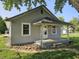 Charming gray vinyl-sided house with a covered front porch and well-manicured lawn at 2041 Mckinley Ave, Columbus, IN 47201