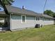 This home has gray vinyl siding, white trim, and a well-maintained green lawn at 2041 Mckinley Ave, Columbus, IN 47201