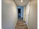 Hallway showcasing wood-look tile flooring and a door leading to the bathroom at 2041 Mckinley Ave, Columbus, IN 47201