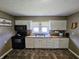 Bright kitchen with white cabinets, modern appliances, and a welcoming sign for a cozy feel at 2041 Mckinley Ave, Columbus, IN 47201
