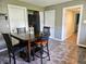 Kitchen area with a dining table and chairs, with multiple doors and tiled floors at 2041 Mckinley Ave, Columbus, IN 47201
