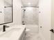 Contemporary bathroom featuring a large mirror, quartz countertop, and bathtub with tiled surround at 2051 Columbia Ave, Indianapolis, IN 46202