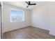 Bright bedroom with neutral walls, wood floor, and a window with natural light at 2053 Columbia Ave, Indianapolis, IN 46202