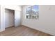 A clean bedroom featuring a closet, a window, and wood flooring at 2053 Columbia Ave, Indianapolis, IN 46202
