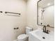 Modern bathroom with white sink, black mirror and toilet at 2427 N Rural St, Indianapolis, IN 46218