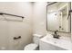 Bright half bath with mirror, faucet, and commode at 2427 N Rural St, Indianapolis, IN 46218