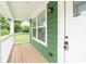This covered front porch features wood decking and is perfect for enjoying the outdoors at 2427 N Rural St, Indianapolis, IN 46218