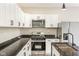 Beautiful kitchen featuring granite countertops, stainless steel appliances, white cabinetry and a modern design at 2427 N Rural St, Indianapolis, IN 46218