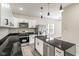 Modern kitchen with stainless steel appliances, granite countertops, a large island, and sleek white cabinets at 2427 N Rural St, Indianapolis, IN 46218