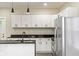 Contemporary kitchen featuring granite countertops, white cabinets, stainless steel appliances, and a spacious layout at 2427 N Rural St, Indianapolis, IN 46218