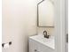 Bright half bath with mirror, faucet, and commode at 2427 N Rural St, Indianapolis, IN 46218