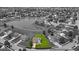 Neighborhood aerial view showcasing a property with a pond in the vicinity and tree-lined streets at 2434 Burgundy Way, Plainfield, IN 46168