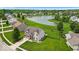 Beautiful aerial view of a well-maintained home, lush greenery, and a tranquil neighborhood pond at 2434 Burgundy Way, Plainfield, IN 46168