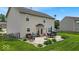 Well-maintained backyard features a patio with comfortable seating, an umbrella, and manicured landscaping at 2434 Burgundy Way, Plainfield, IN 46168