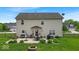 Spacious backyard with a patio seating area, grill, and a fire pit for outdoor entertaining at 2434 Burgundy Way, Plainfield, IN 46168