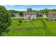 Large backyard featuring a well-maintained lawn, mature trees, and a classic wooden fence at 2434 Burgundy Way, Plainfield, IN 46168