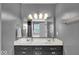 This bathroom features gray walls, double sinks, a large mirror, and gold accents at 2434 Burgundy Way, Plainfield, IN 46168
