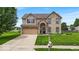 Charming two-story home featuring a landscaped front yard, brick facade, and attached two-car garage at 2434 Burgundy Way, Plainfield, IN 46168