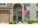 Inviting front entrance featuring a black door, rocking chair, and tasteful landscaping details at 2434 Burgundy Way, Plainfield, IN 46168