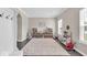 Bright playroom with a large rug, play kitchen, toy storage, and natural light from the windows at 2434 Burgundy Way, Plainfield, IN 46168