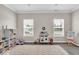 Spacious playroom featuring natural light, a large rug, a play kitchen, and practical toy storage at 2434 Burgundy Way, Plainfield, IN 46168