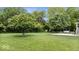 Lush backyard with mature trees and pristine lawn at 2818 Locust Dr, Indianapolis, IN 46227