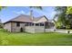 Spacious backyard showcasing a deck, screened porch, lush lawn, and mature trees at 2818 Locust Dr, Indianapolis, IN 46227