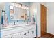 Bathroom featuring a double sink vanity with modern fixtures, and a wood-look floor at 2818 Locust Dr, Indianapolis, IN 46227