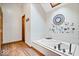 Bright bathroom with a soaking tub, skylight, and wood-look flooring at 2818 Locust Dr, Indianapolis, IN 46227