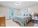 Comfortable bedroom with a patterned bedspread, soft carpet, and bright natural light at 2818 Locust Dr, Indianapolis, IN 46227