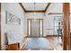 Inviting foyer featuring wood floors, wooden trim, accent furniture and a decorative light fixture at 2818 Locust Dr, Indianapolis, IN 46227